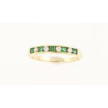 An 18ct H/M emerald & diamond half eternity ring, approx 2.
