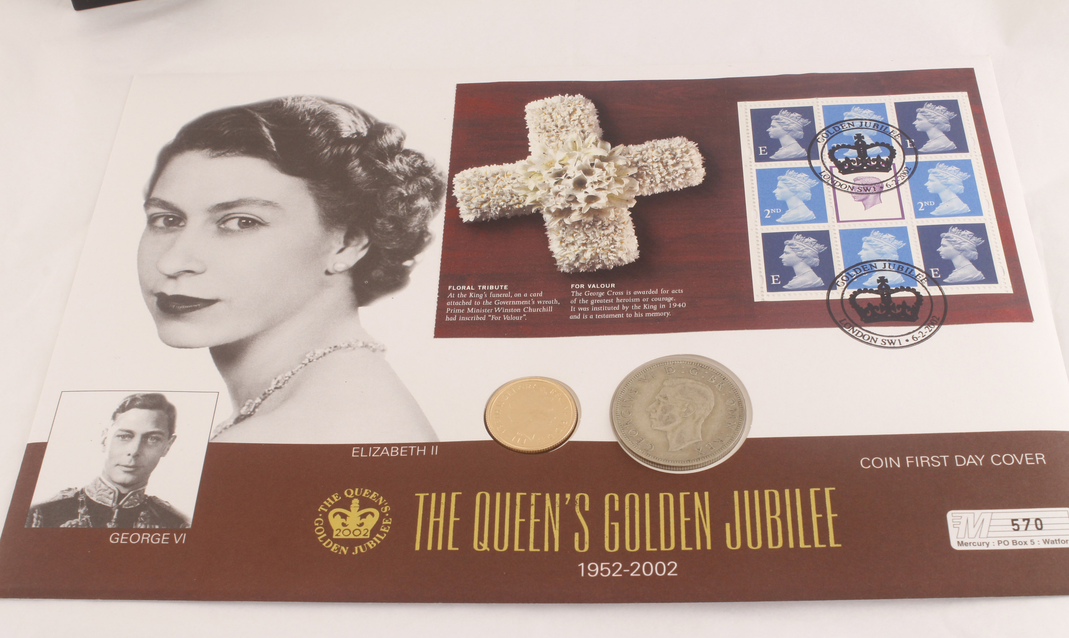 A 2002 gold sovereign coin cover commemorating The Queens Golden Jubilee,