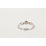 An 18ct white gold three stone diamond ring with marquise shaped stones to the shoulders,