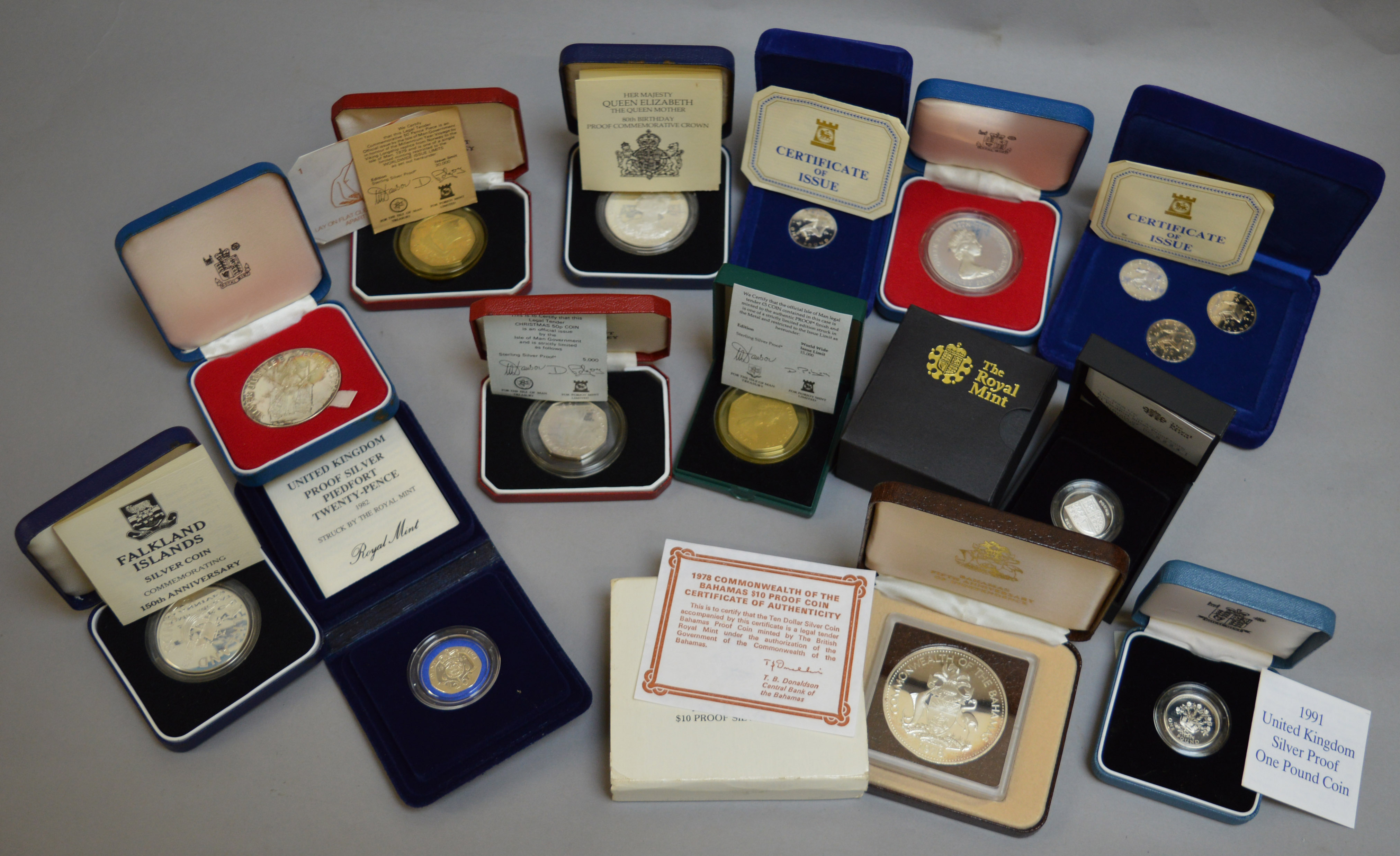 Thirteen silver proof coins in cases with certificates to include Bahamas, Falklands,