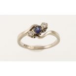 A diamond & sapphire three-stone twist set ring, the white mount marked 18ct, approx 4gms,