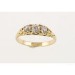 An Edwardian three stone diamond ring marked 18ct, the old-cut stones totalling 0.60ct, approx 2.