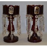 A pair of late 19th/ early 20th century ruby glass gilt lustres. 8 drops each. 30cm tall.
