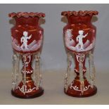 A pair of late 19th/early 20th century cranberry glass lustres with Mary Gregory style overlay.