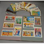 A large quantity of humorous and innuendo postcards, some loose and some contained in an album,