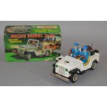 A boxed TN Nomura Japanese tinplate battery operated Police Patrol Jeep,