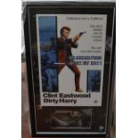 A Dirty Harry poster framed and glazed with a replica of the Smith & Wesson revolver shown in the