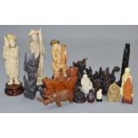 A collection of various oriental figures including wooden and resin examples.