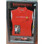 A Ferrari shirt signed by Fernando Alonso with a photograph of him, framed and glazed.