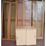 3 large shelving units with doors together with two chests of drawers