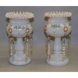 A pair of late 19th/ early 20th century opaque white blown glass lustres with hand painted flower