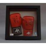Two signed boxing gloves. One signed by Amir Khan, the other by Haroon Khan. Framed & Glazed.