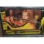 A Kill Bill poster framed and glazed with a replica of the sword shown in the movie. 121cm x 91cm.