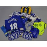 A collection of mostly 1990s/early 2000s Everton FC football shirts and two scarves.