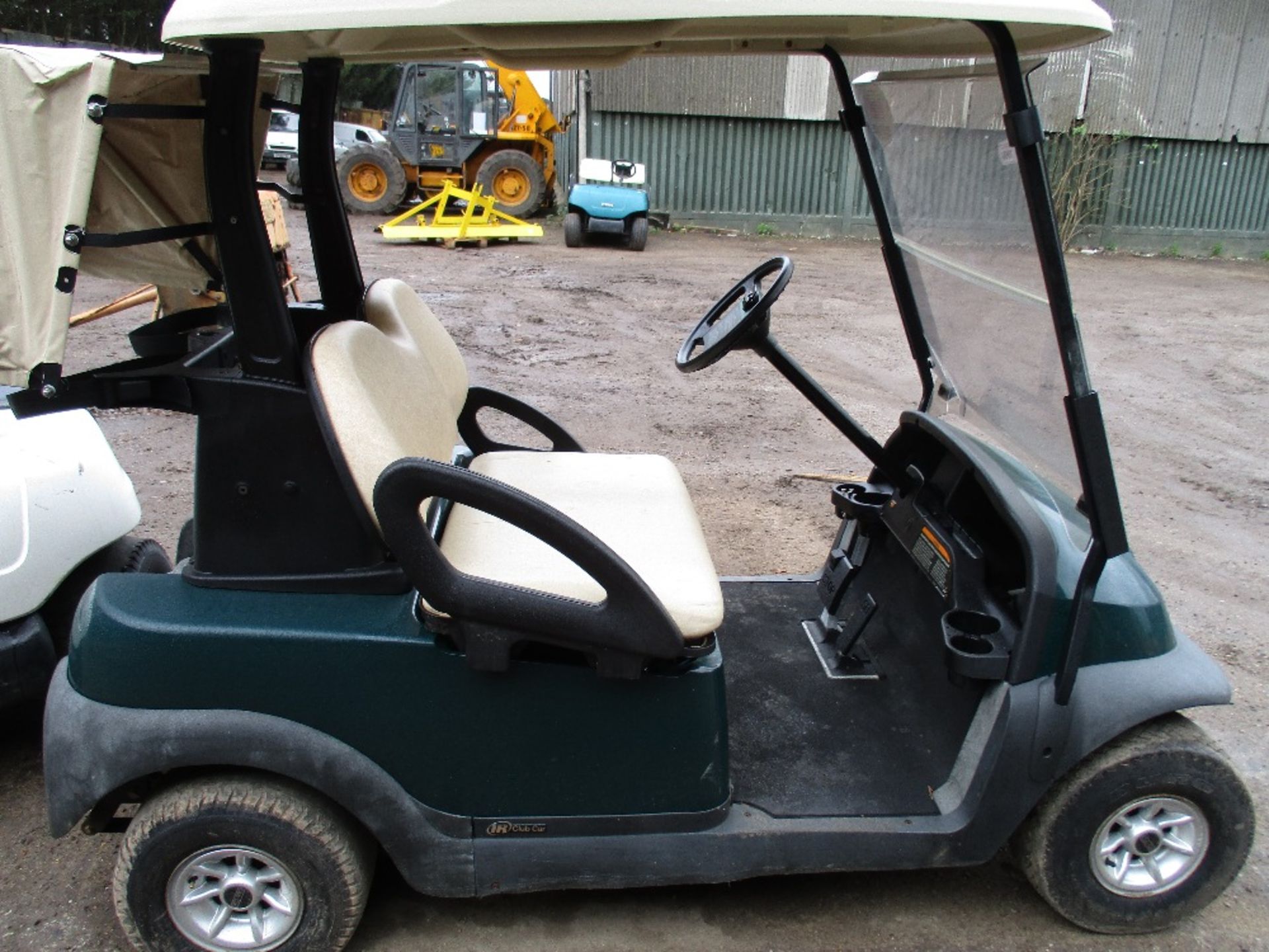 Club Car electric powered golf cart with roof green. Battery low untested