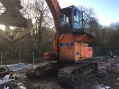 Hitachi EX215 tracked excavator with fixed high cab fitted with selector grab.