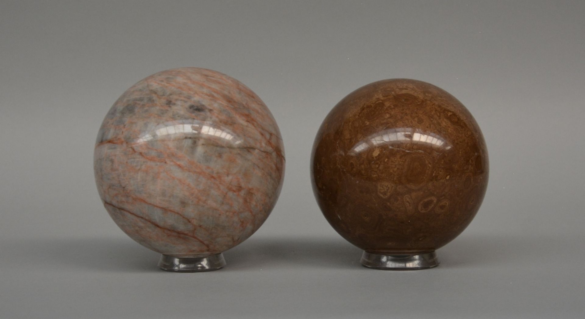 Two decorative marble balls on acrylic bases, H 14 - 15,5 cm