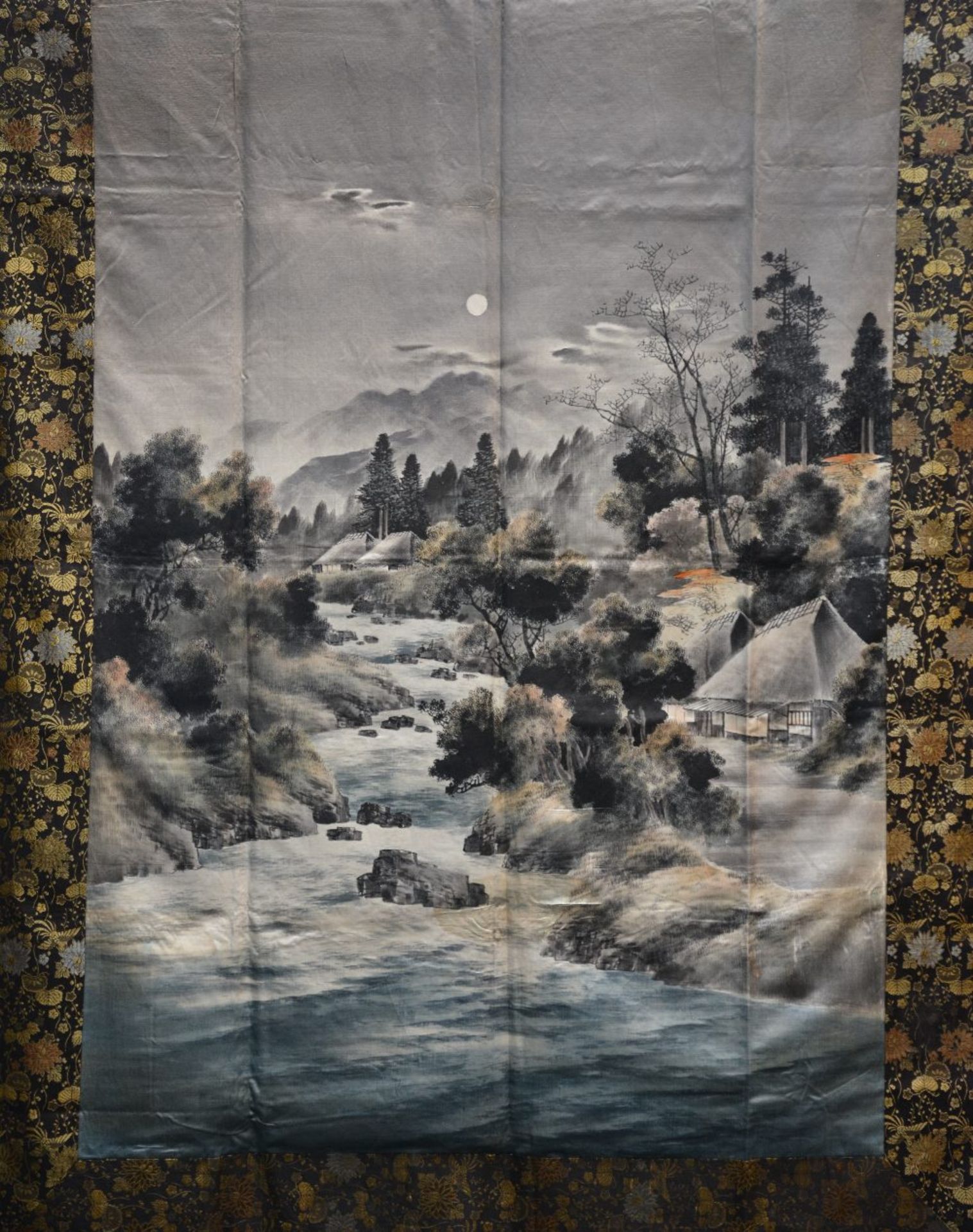 An Oriental watercolour on silk depicting a mountainous landscape with a river, 127 x 171 cm