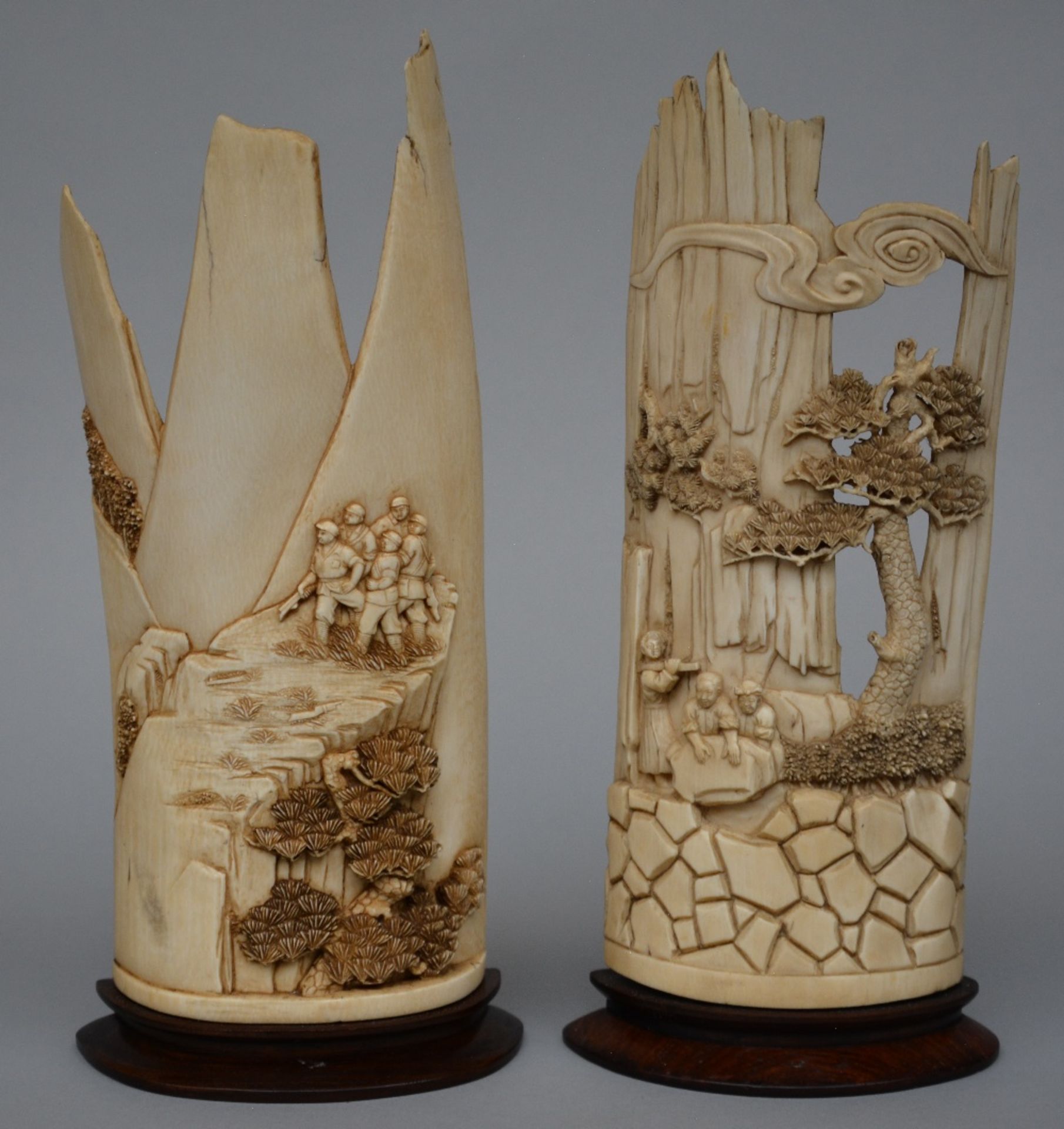 Two ivory plaques carved with animated scenes in a landscape, on a fixed wooden base, Republic