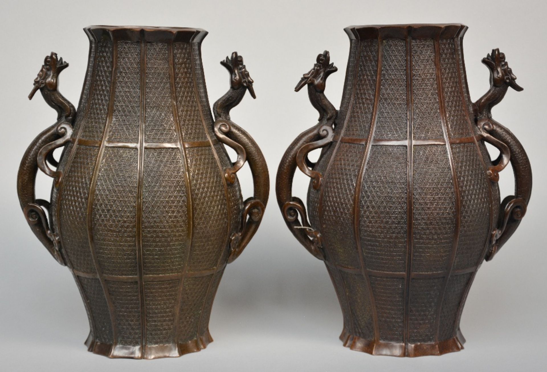 A pair of Oriental bronze vases with dragon relief decorations, marked, 19thC, H 37 cm