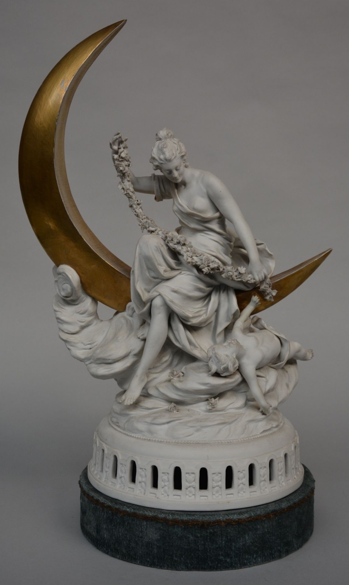 An allegorical statue in biscuit, partially gilt, late 19thC, H 49 cm (damage on the flower