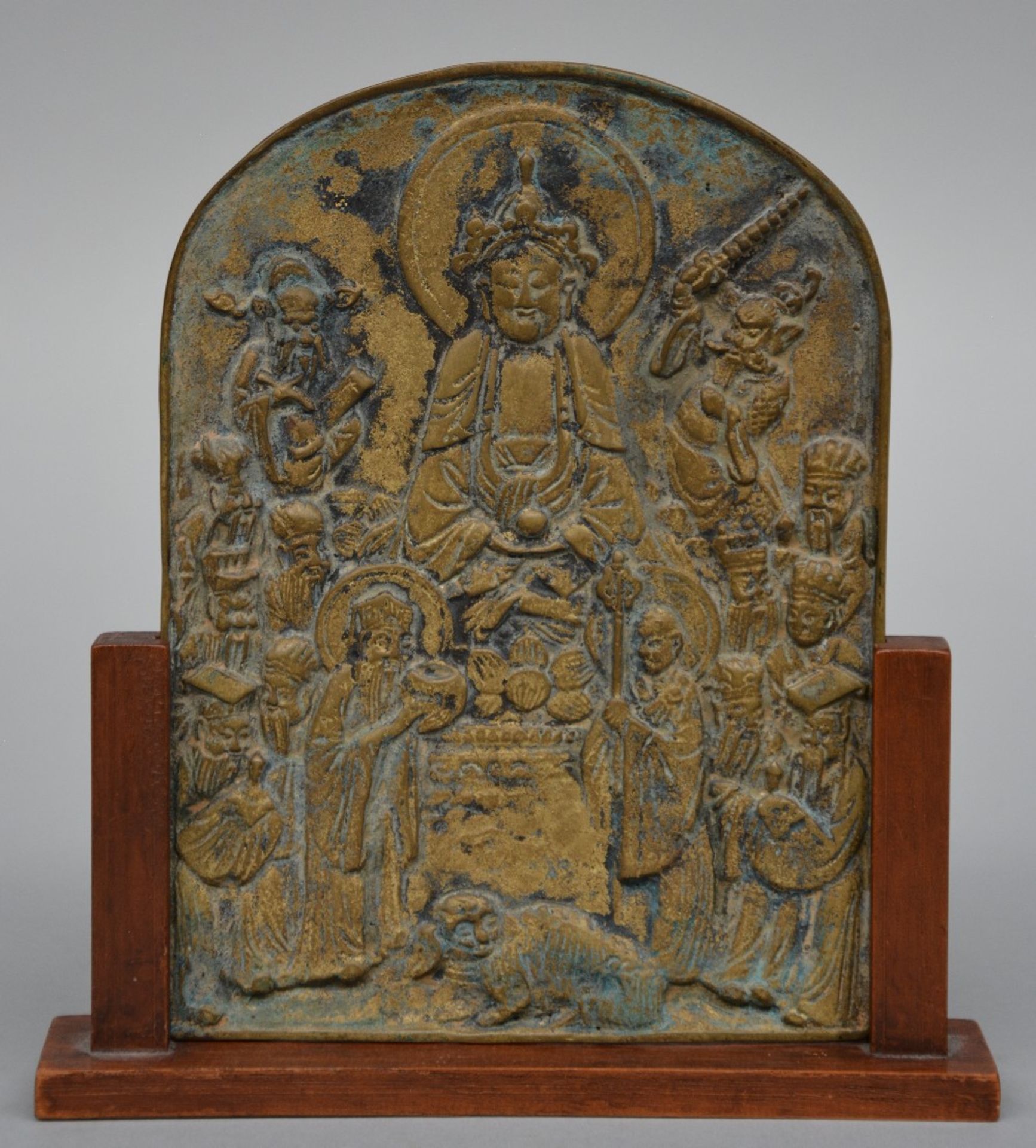 A Chinese bronze plaque in a wooden frame with relief decoration depicting the life story of