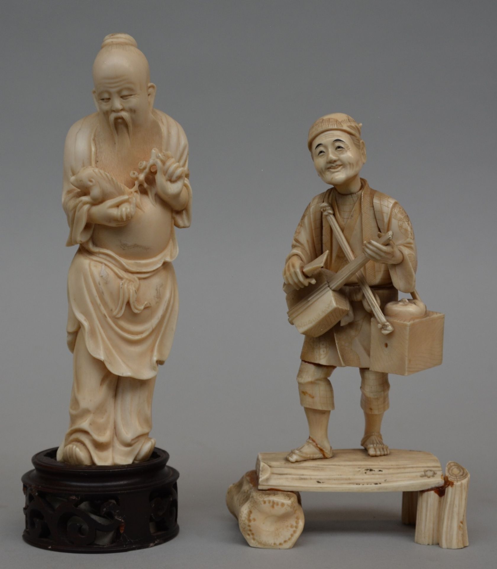 A Japanese ivory okimono figure of a peddler, scrimshaw decorated, Meiji period, H 20 cm; added a