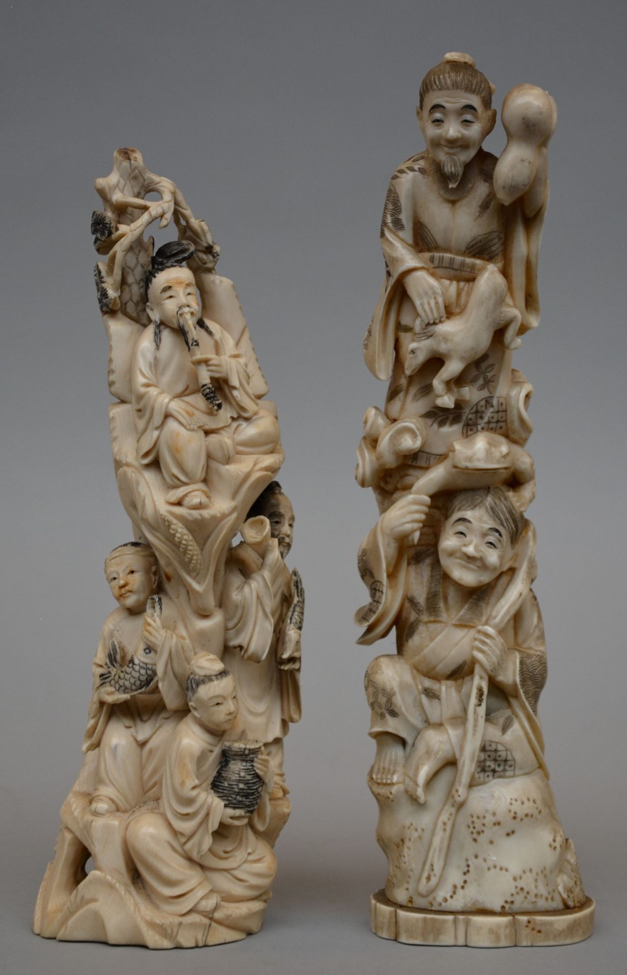 A Japanese ivory okimono depicting two mythical characters, scrimshaw decorated, Meiji period, H