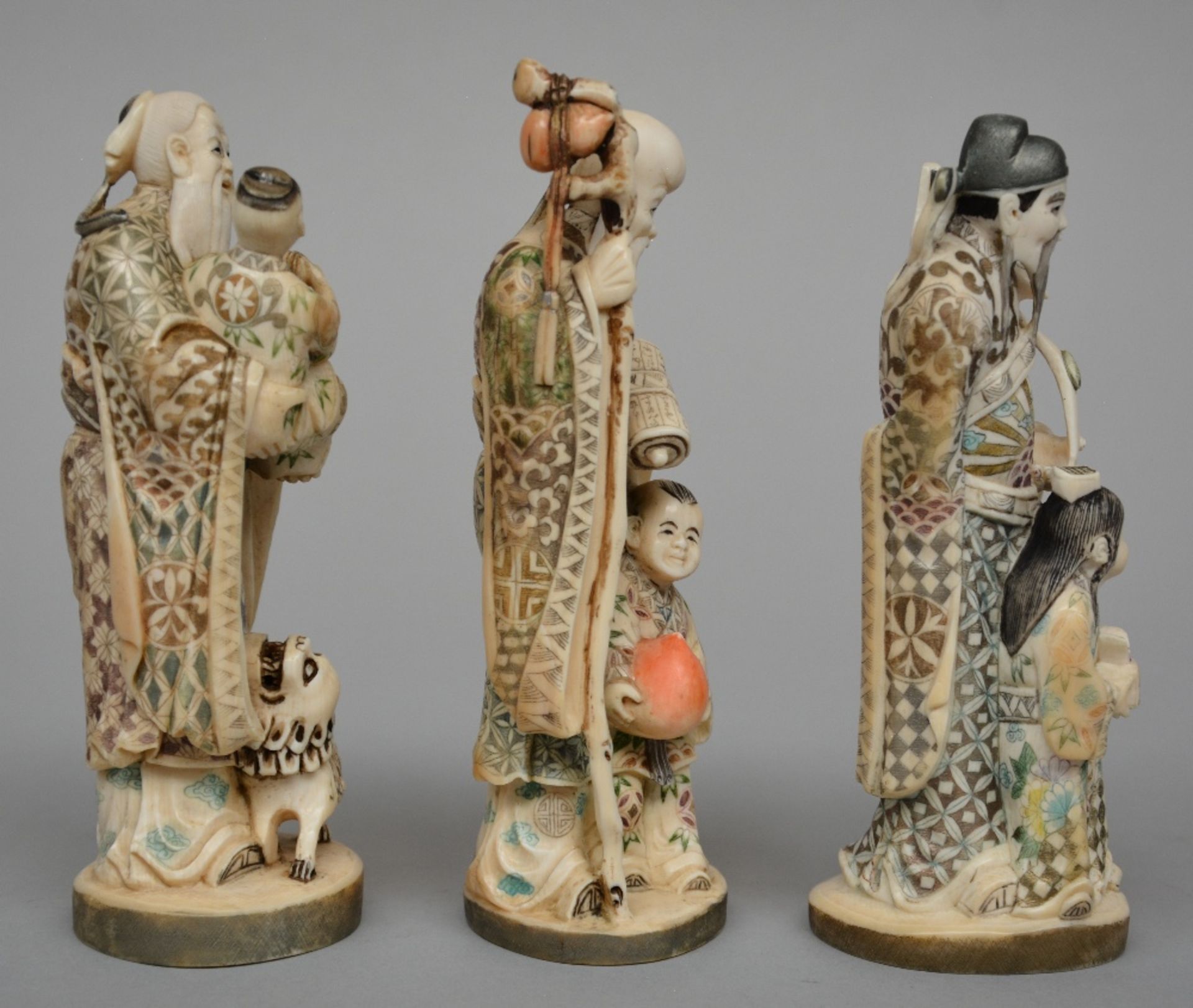 Three Japanese ivory okimono of mythological figures, scrimshaw decorated and partially - Image 4 of 7