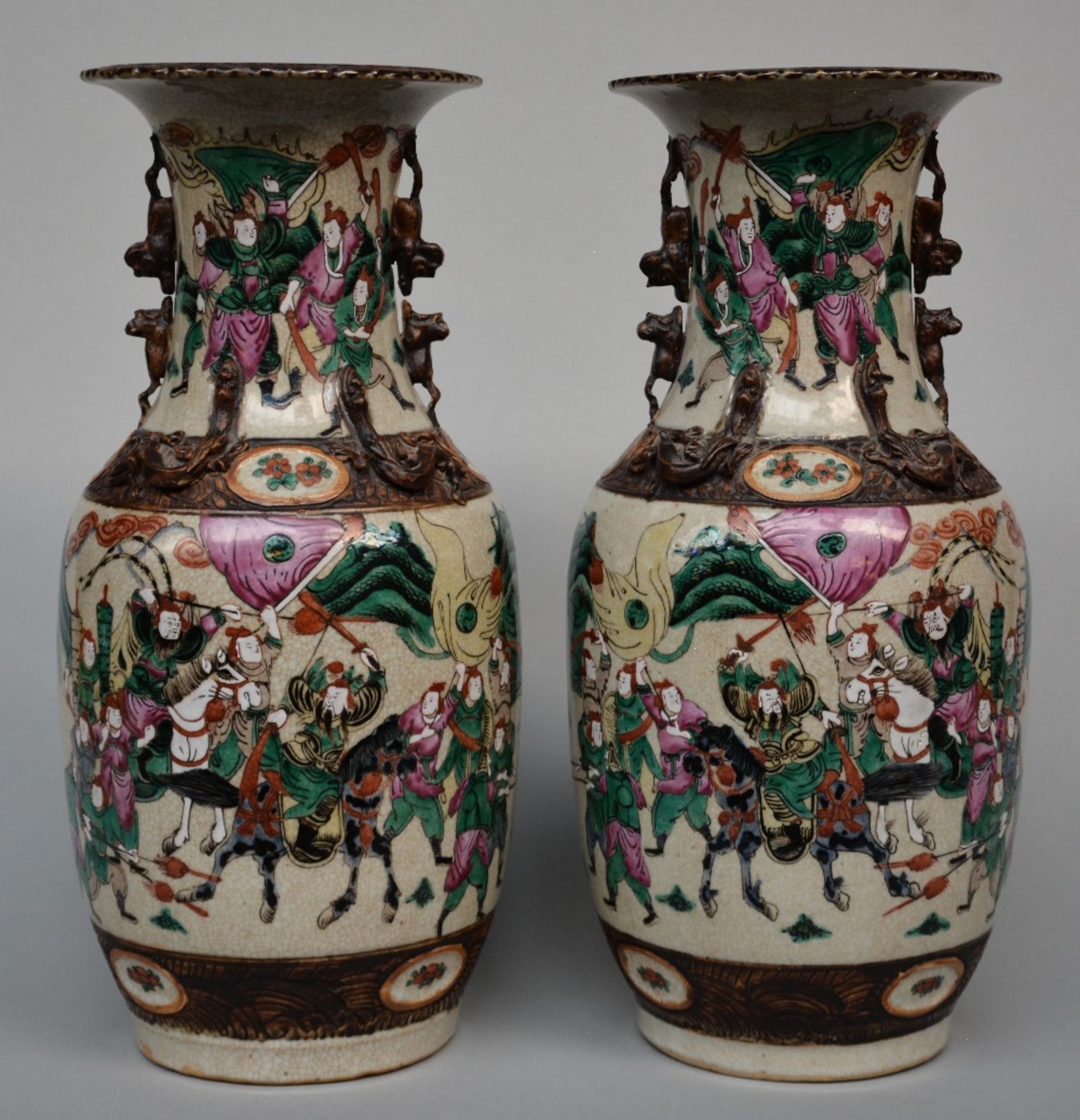A pair of Chinese polychrome stoneware vases, decorated with a warrior scene, marked, 19thC, H 44 cm