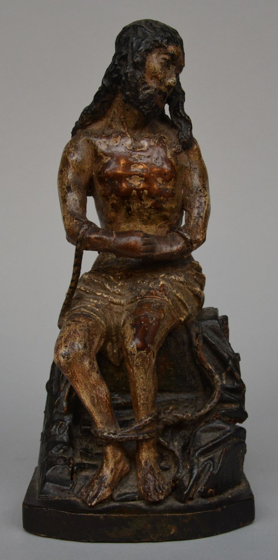 A late 17thC carved and painted limewood figure of 'Christ sitting on the cold stone', H 33 cm (