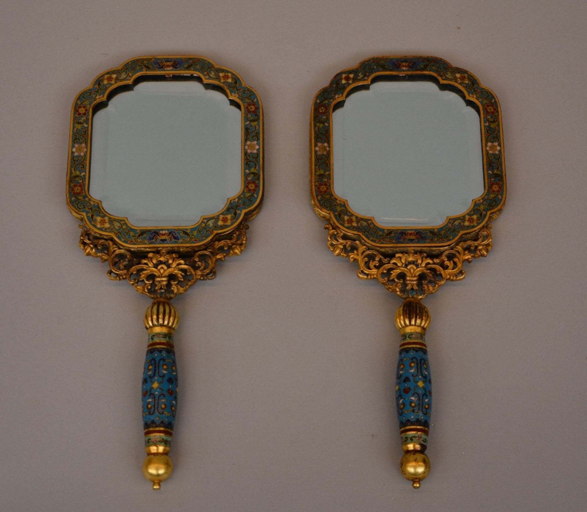 A pair of exceptional Chinese hand mirrors, gilt bronze and cloisonné decoration, the back side