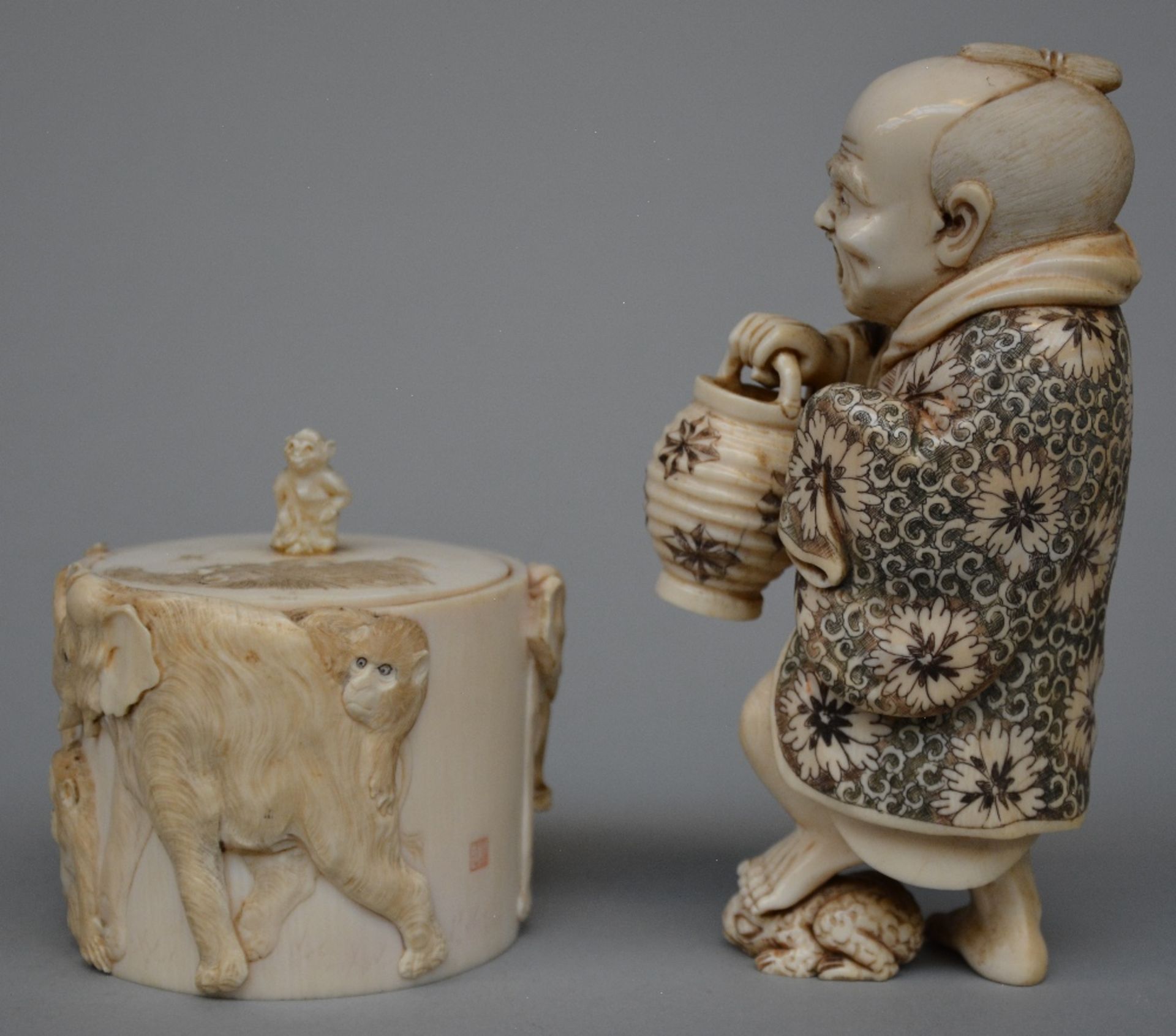 A Japanese ivory okimono of a man holding a lantern and stepping on a toad, scrimshaw decorated, - Image 2 of 7