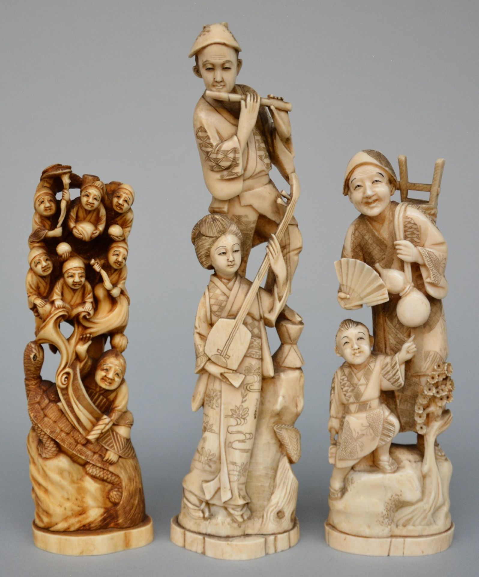Three Japanese ivory okimono, scrimshaw decorated and tinted, Meiji period, H 29,5 cm - Weight 618 g