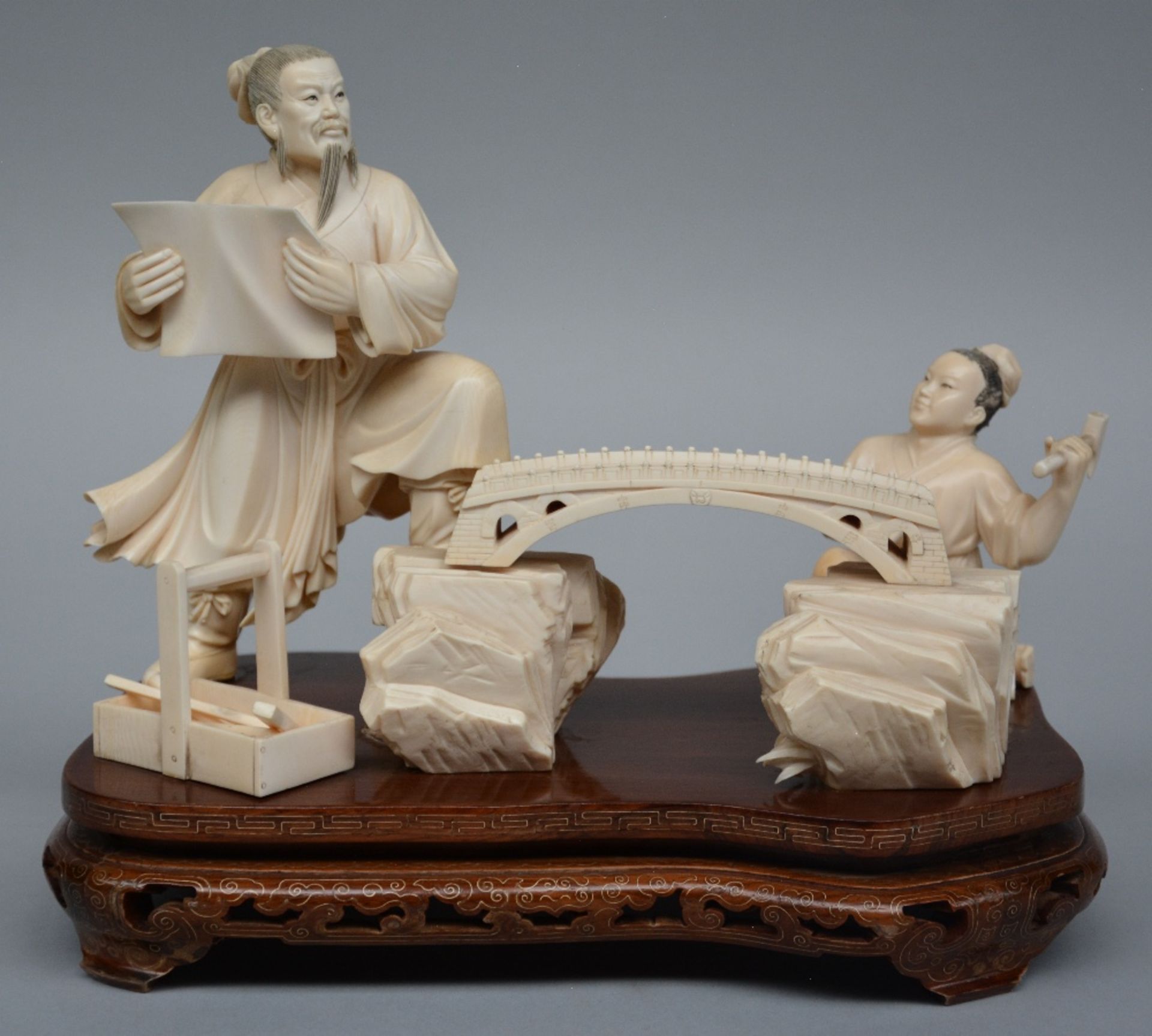 An exceptional Oriental ivory group on a wooden base, ca. 1900, H 24,5 - W 30 cm