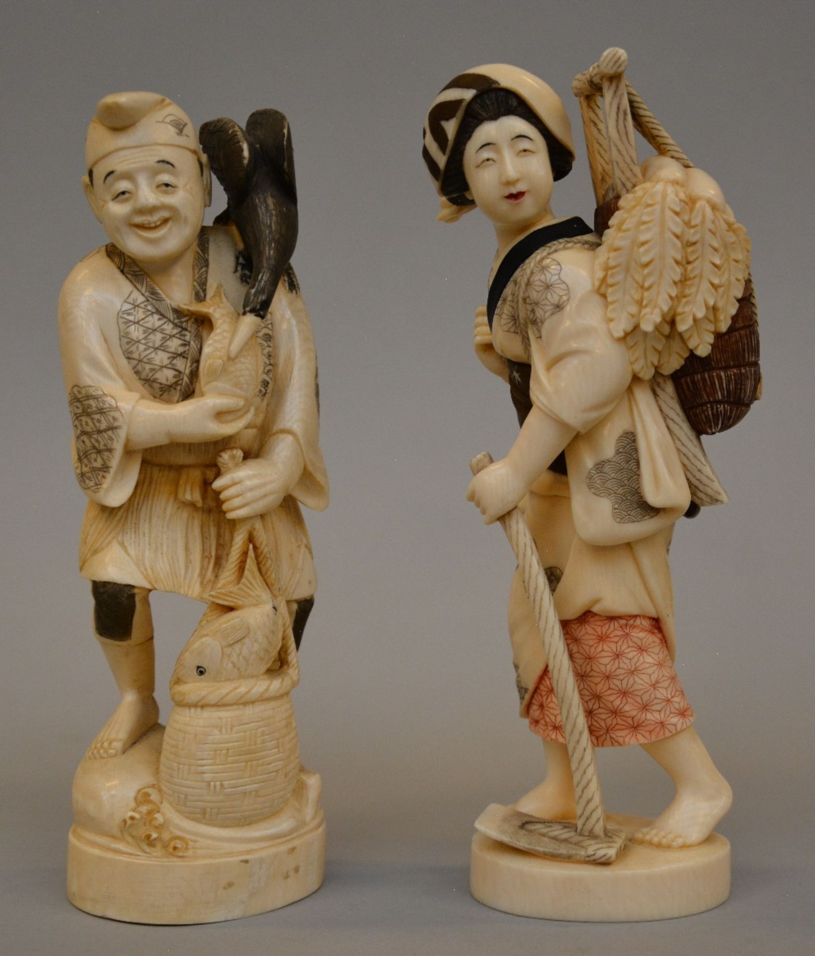 Two Japanese ivory okimono of country folks, scrimshaw decorated and tinted, late Meiji period, H