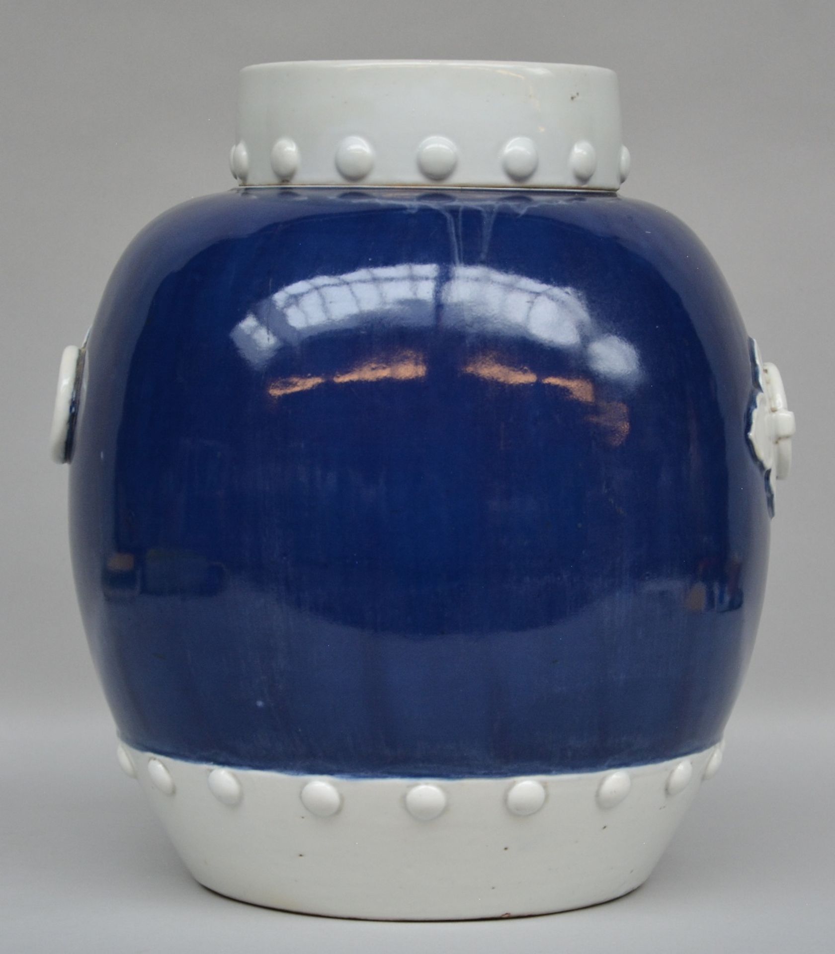 A Chinese blue and white jar with cover, decorated with relief, 19thC, H 41 cm (minimal chips on the
