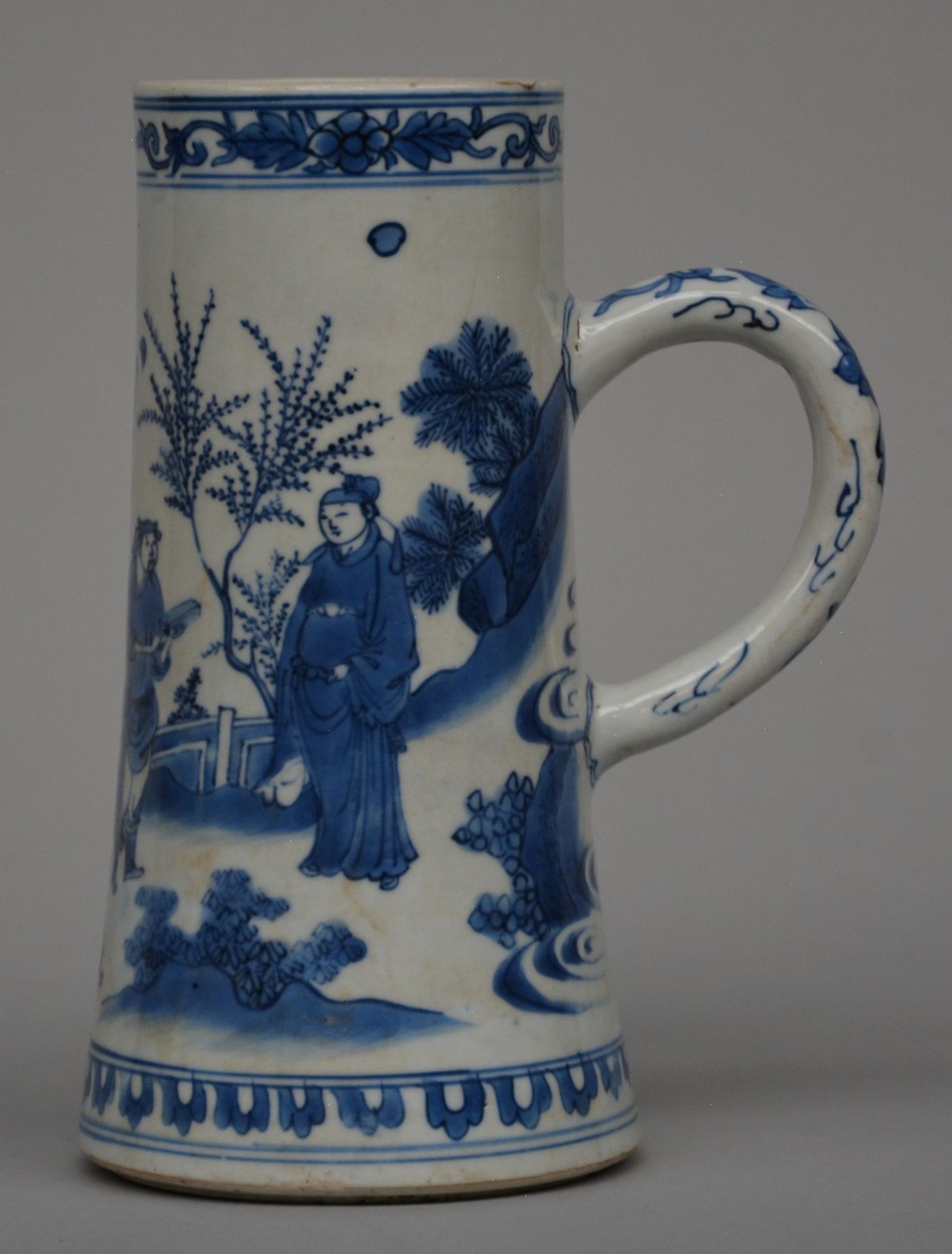 A Chinese blue and white jug, decorated with two figures in a landscape, Transitional period, H 20