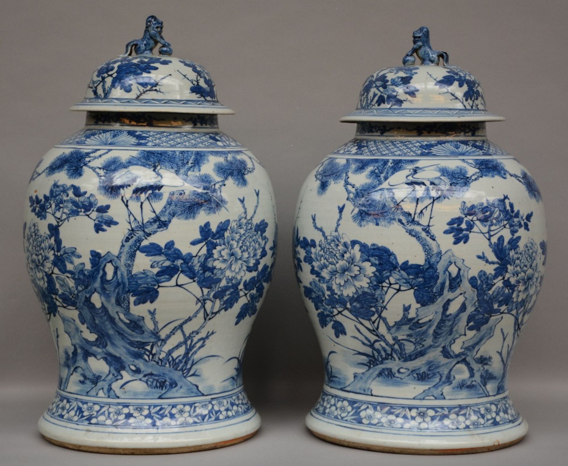 A pair of impressive Chinese blue and white vases with cover, decorated with the image of birds on a