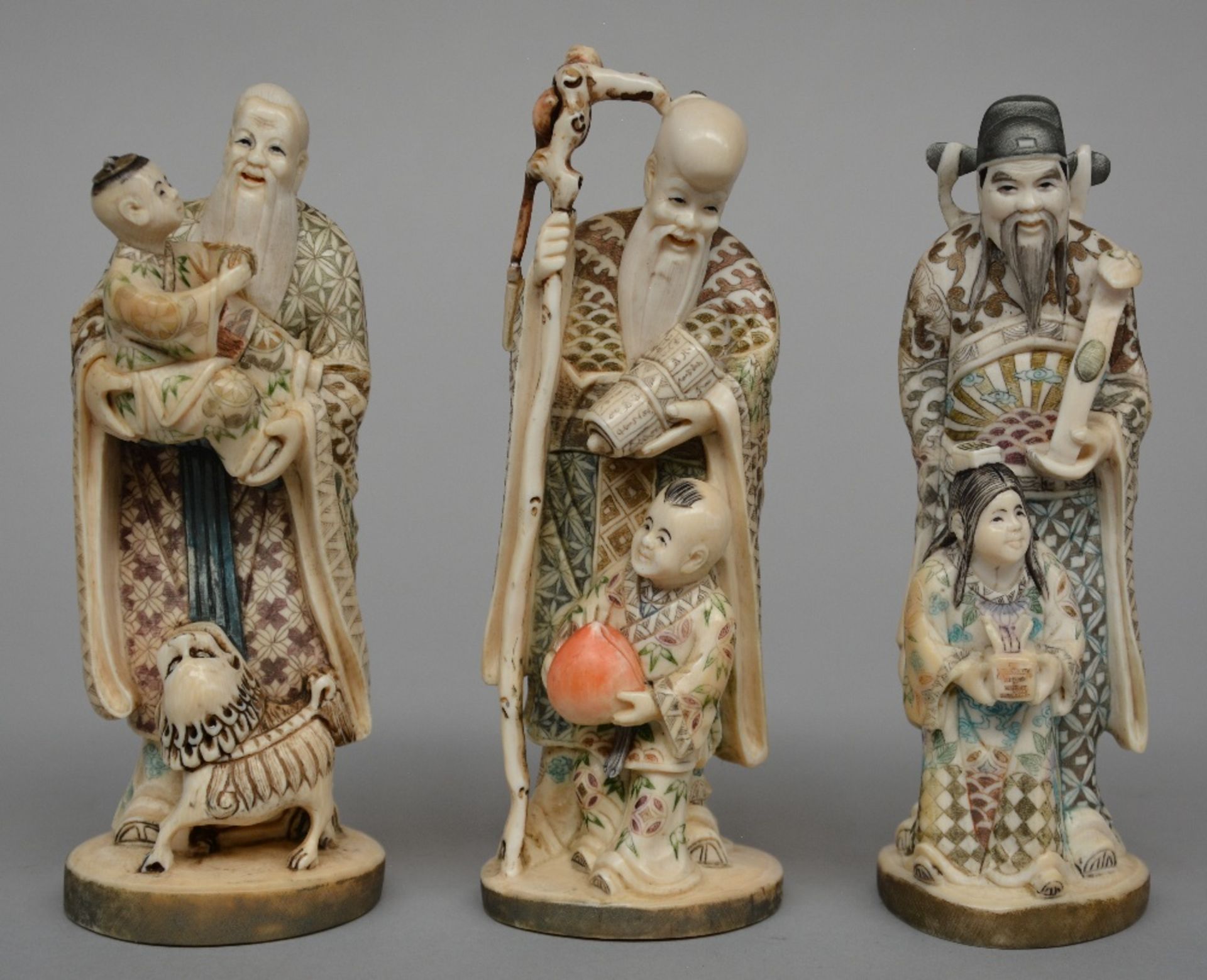 Three Japanese ivory okimono of mythological figures, scrimshaw decorated and partially