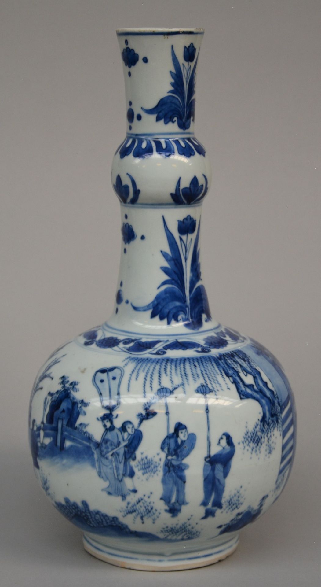 A Chinese blue and white bottle-shaped vase decorated with a genre scene in a garden, Transitional