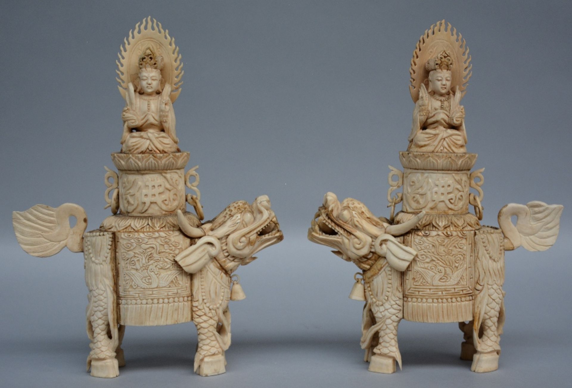 A pair of bone sculptures of Buddha sitting on a Qilin, first half of 20thC, H 26 cm