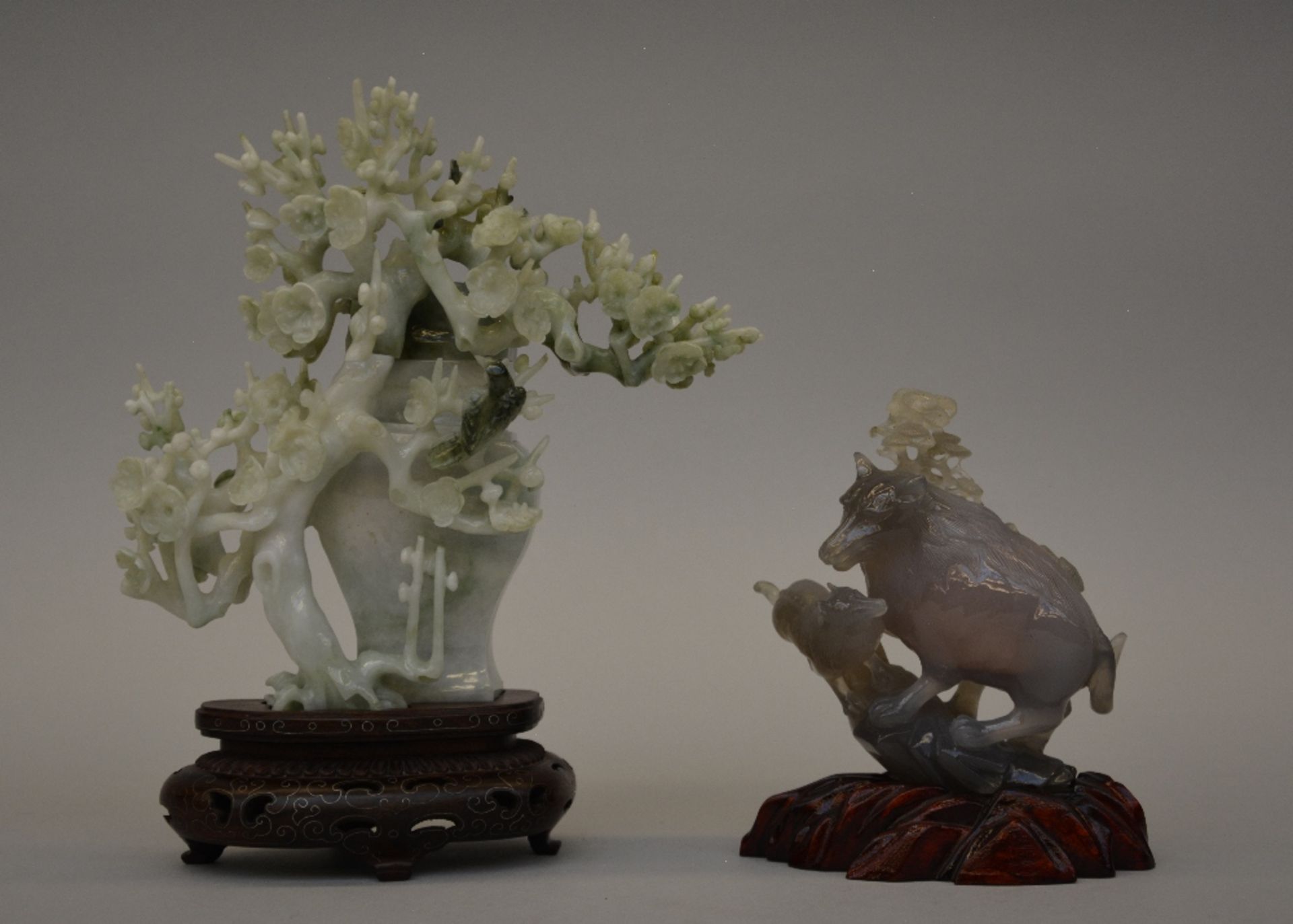 Two Chinese gemstone carvings (small vase with cover and dog with puppy), 20thC, both with wooden