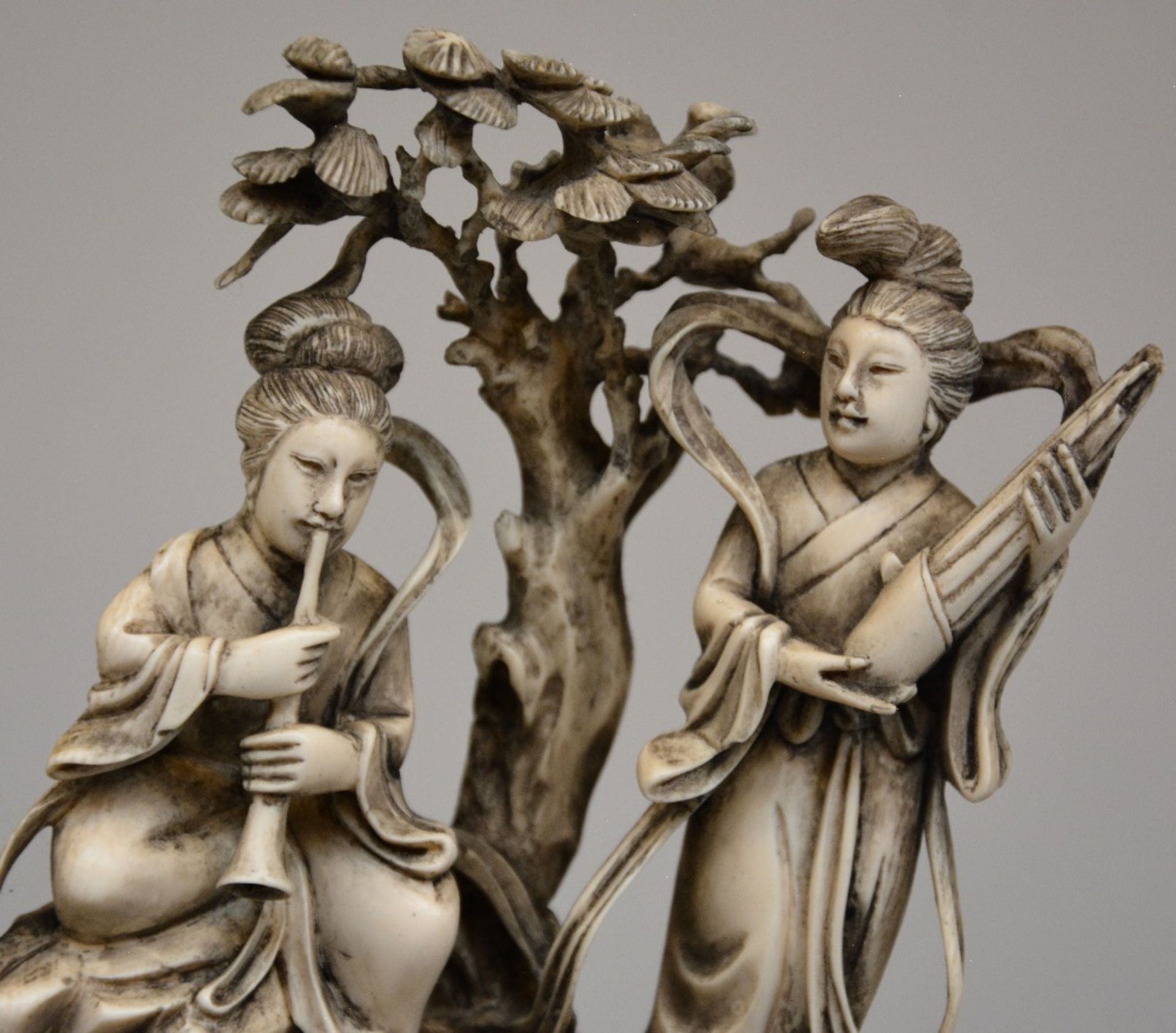 A Chinese ivory sculpture carved with ladies playing music in a landscape, on a fixed wooden base, H - Bild 4 aus 4
