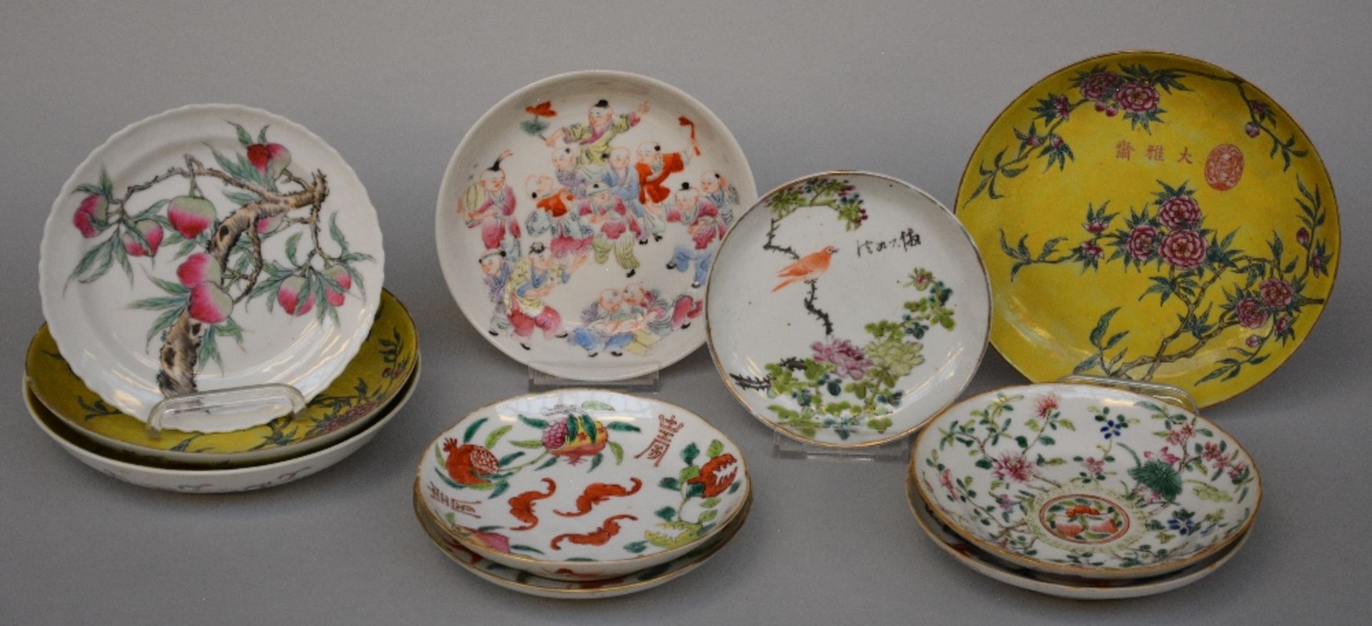 Ten Chinese polychrome decorated plates depicting figures, flowers, fishermen, birds, and peaches,