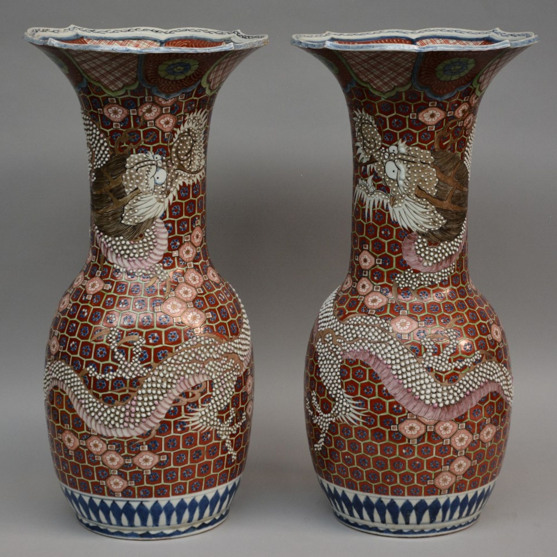 A pair of exceptional Japanese polychrome vases with relief decorations of dragons, marked, 19thC, H