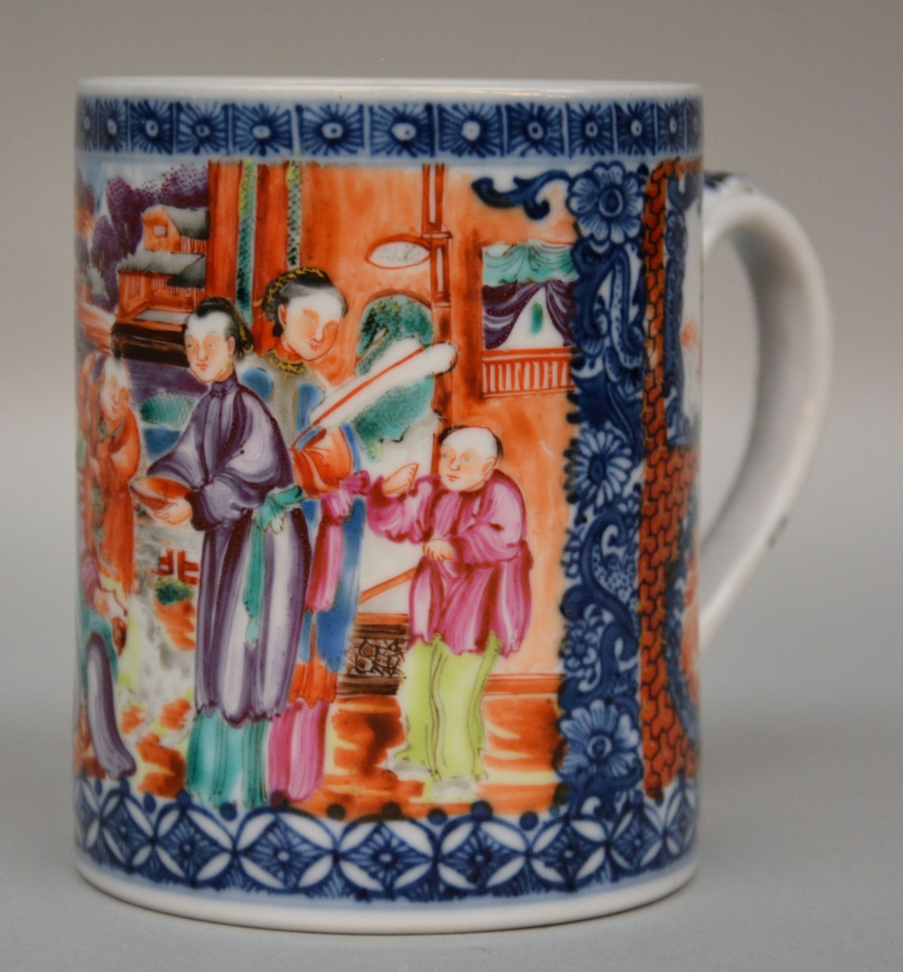 A Chinese polychrome tea mug, decorated with figures on a terras overlooking a river, Mandarin