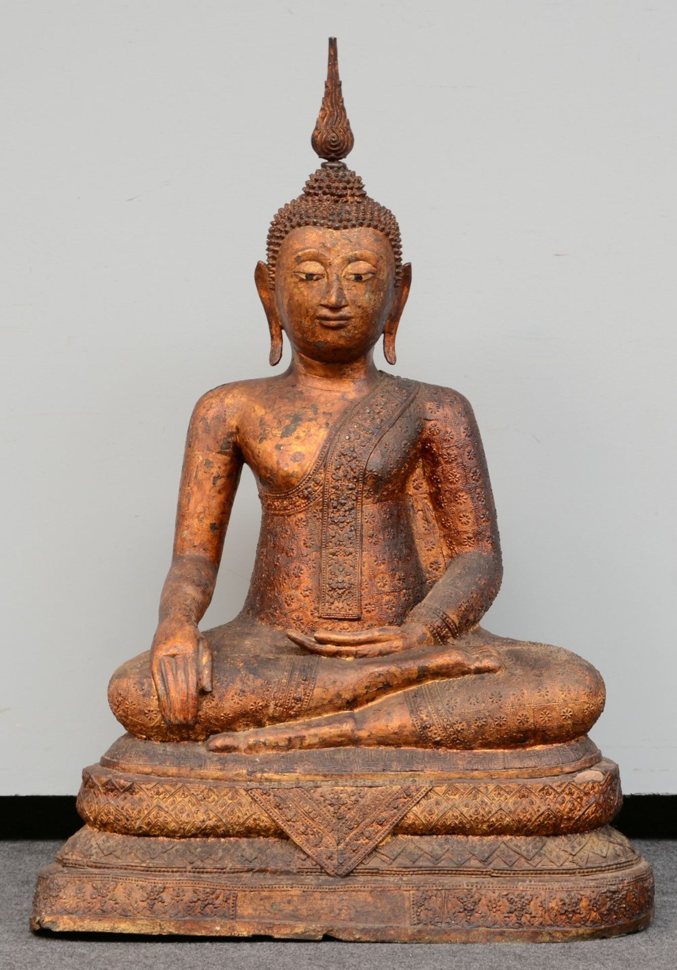 An Oriental gilt bronze Buddha, relief decorated, inlaid with glass, 19thC, H 102 - W 70,5 cm (