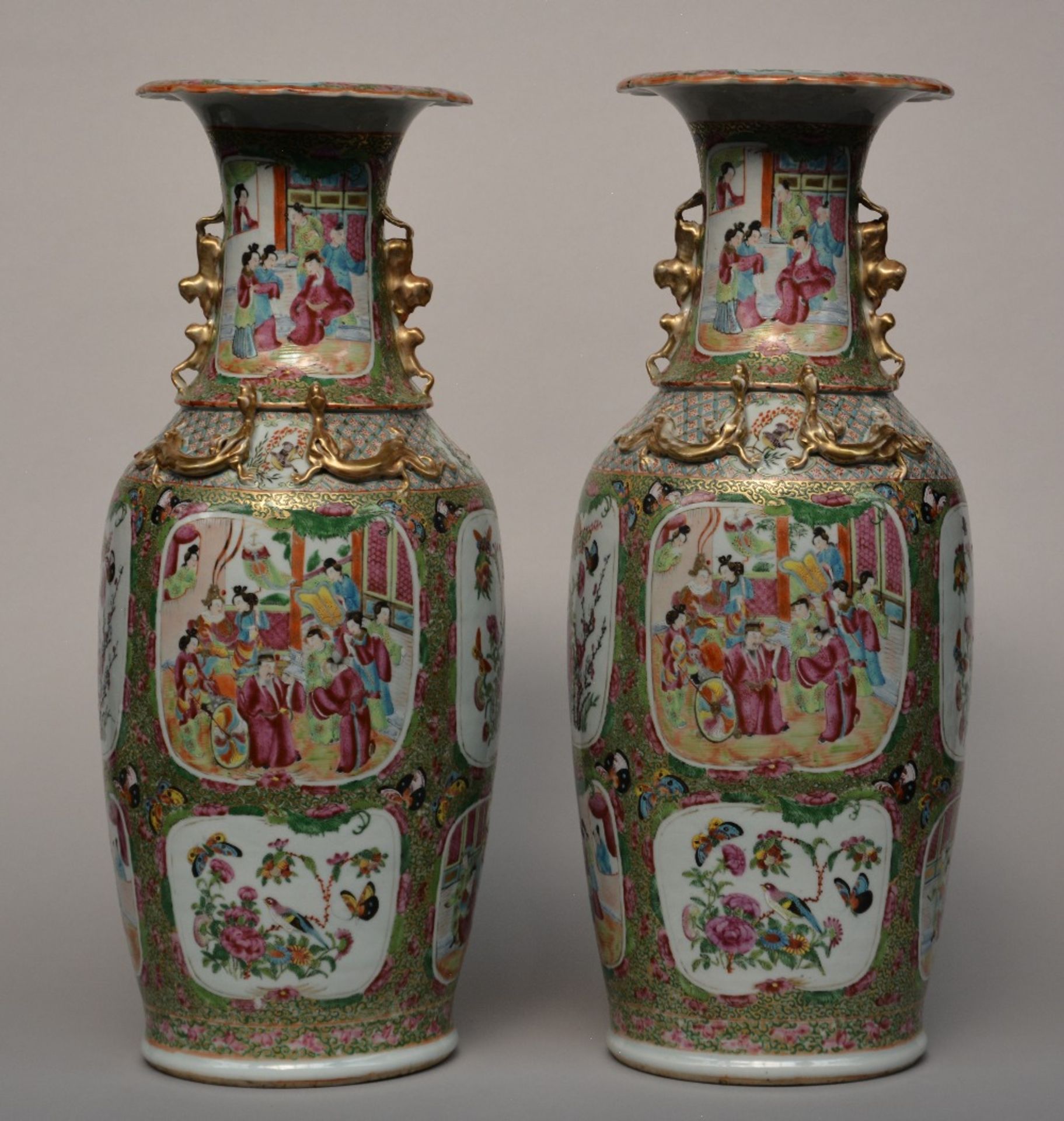 A pair of Chinese Canton vases with animated scenes and relief decoration, 19thC, H 61,5 cm (one