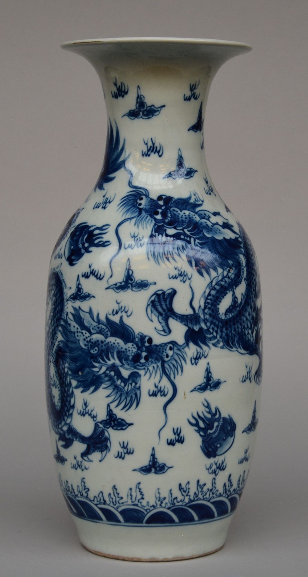 A Chinese blue and white vase, decorated with dragons, H 55,5 cm (minor chips on the rim and some